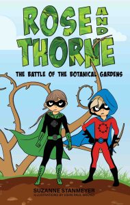 The cover of Rose and Thorne: The Battle of the Botanical Gardens by Suzanne Stanmeyer, with illustrations by John Paul Bronzi, features two young masked superheroes standing in a botanical garden overtaken by large twisting thorn vines. The girl superhero wears a black and green costume with a green cape and leaf-inspired details. The boy superhero wears a red and black costume with a blue hood and cape. The title appears in large green letters filled with leaf patterns, emphasizing the garden adventure theme.